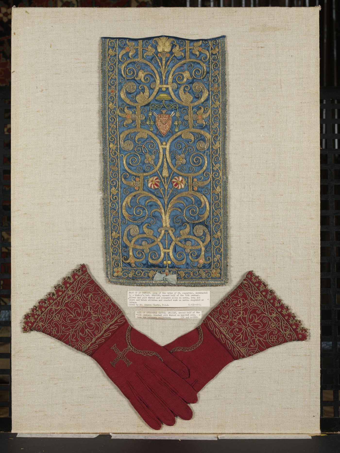 Pair of episcopal gloves, couched gilt thread on red knitted silk from the V&A collection. Source (http://collections.vam.ac.uk/item/O363886/pair-of-gloves-unknown/)