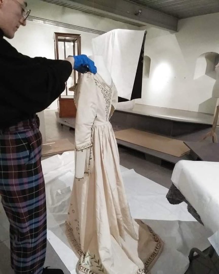 Lucy McConnell mounting the embroidered silk dress, c. 1905, part of Leicestershire Museums’ collection. Image courtesy of Lucy McConnell.