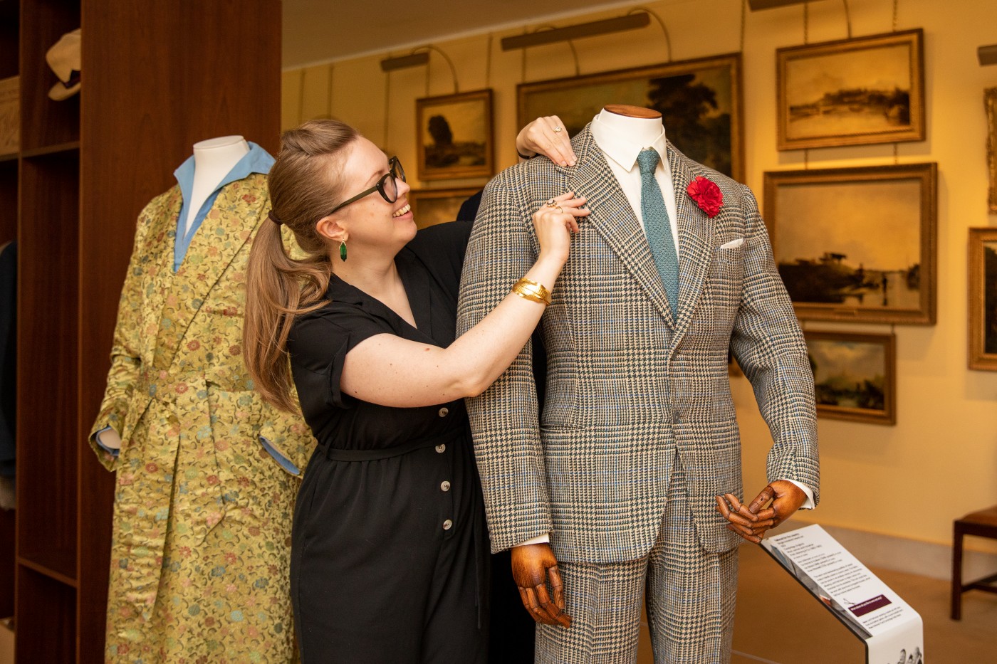 Roisin Semple checks the lapel of Lord Fairhaven's suit in Tailoring an Image at Anglesey Abbey, credit National Trust Images Mike Selby