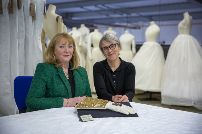 Deborah Moore, CEO of Dents and Rosemary Harden, Fashion Museum Manager at Dents Headquarters with a duplicate of King George VI’s Coronation Glove