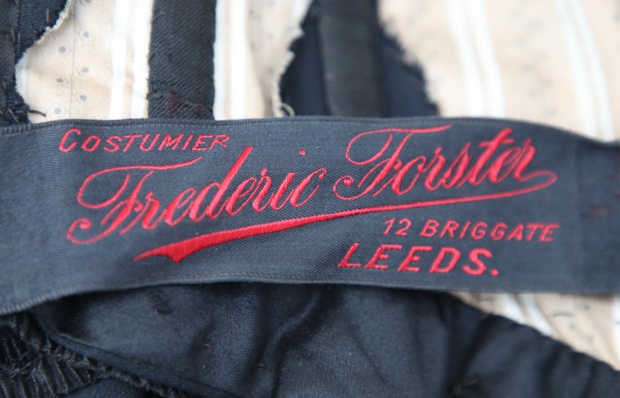 Frederic Forster label on bodice interior waistband. LMG accession no. LEEAG.2011.0273 A. Photograph by Michael Anderson.
© Courtesy of Leeds Museums and Galleries