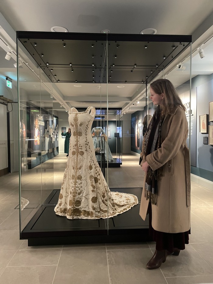 Charlotte alongside the Coronation toile which is accented with gold detailing and was crafted by Handley-Seymour for the coronation of George VI and Queen Elizabeth (later the Queen Mother) on 12th May 1937 at Westminster Abbey.