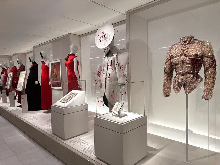 Vital Body:  Vivienne Westwood (British) Mr. Pearl Martyr to Love jacket. Embroidered Silk Satin & Polychrome glass, crystals and clear pailettes, 1996-97 Man. Robert Wun (Hong Kong) Bleeding Coat 2024. Vital Body Diorama. Costume Art © Photo Jane Francis