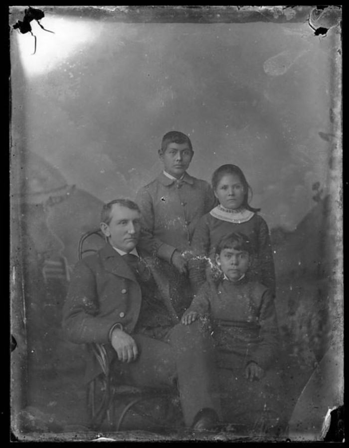 Richard Henry Pratt with three young students, c. 1881. Carlisle Indian School Digital Resource Center
