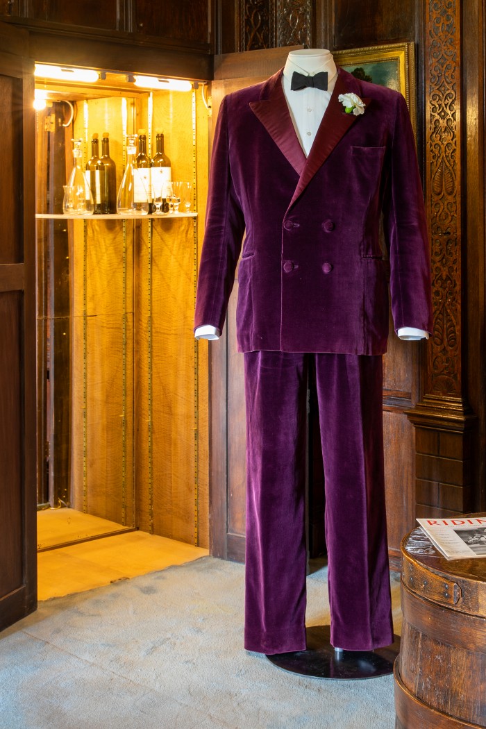 Lord Fairhaven's wine coloured velvet smoking suit on display in Tailoring An Image at Anglesey Abbey, credit National Trust Images Mike Selby