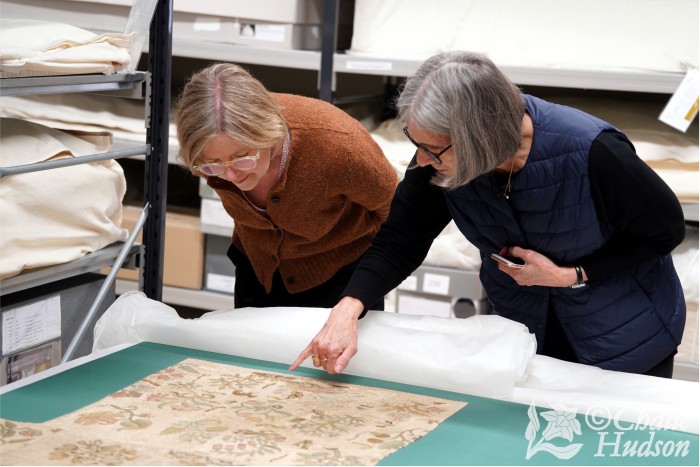 Cynthia Jackson explaining some of the BACStitch Group’s recent research to a curator during a visit to the store rooms at Hampton Court Palace. Image Credit: Challe Hudson