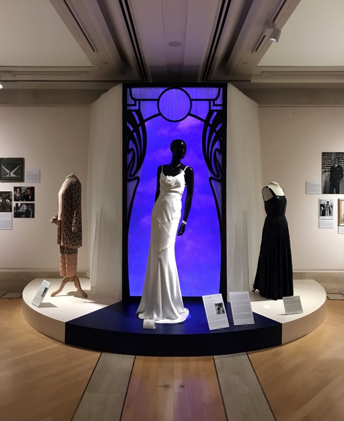 Left to right; Crepe de chine pyjama suit costume worn by Yvonne Bose in Charlot’s Revue of 1926, Modern reconstruction of white satin bias-cut dress costume worn by Gertrude Lawrence in Private Lives, 1930, Midnight blue crepe and sequin dress designed by Edward Molyneux 1935-9. Photograph by author.