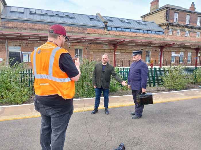 Recording video describing to camera the clothing by a 1950s engine driver.